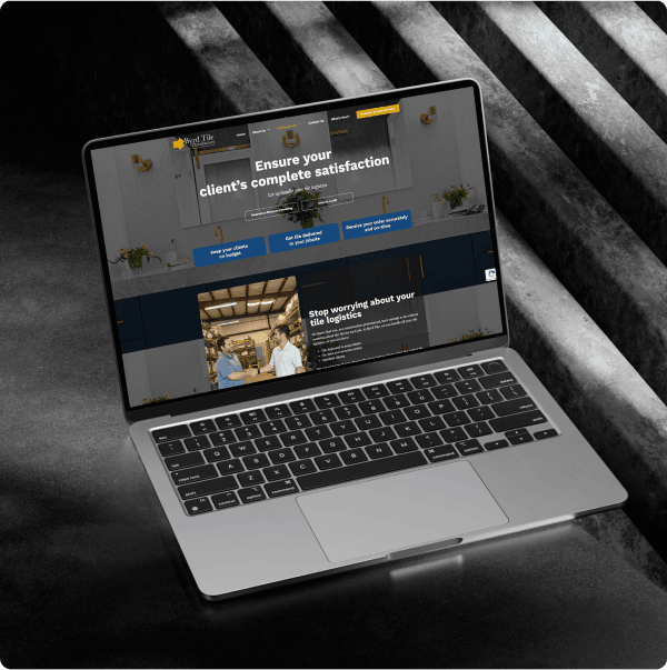 The trade page for tile professionals shown on an angled laptop