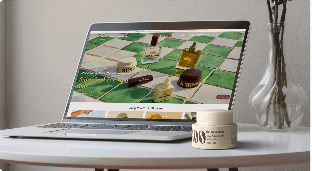 The Sun & Moo homepage on a laptop beside one of its products